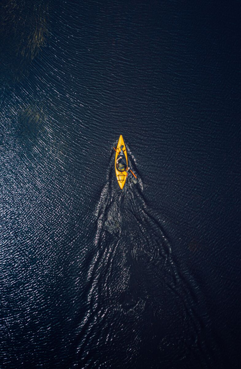 person kayaking on the ocean